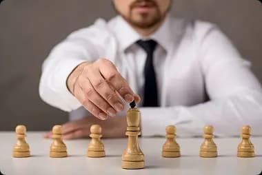 /images/aboutUs/front-view-businessman-holding-king_23-2148569086 1.webp